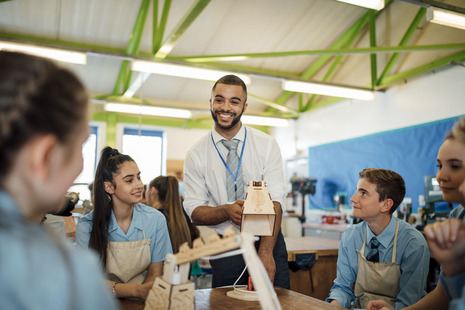A teacher with some students in a school classroom
